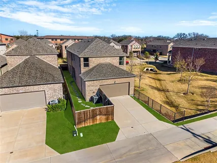 an aerial view of residential houses with outdoor space