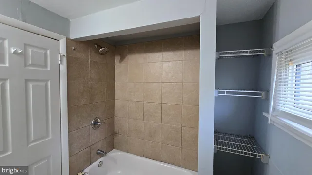 an empty room with windows and closet