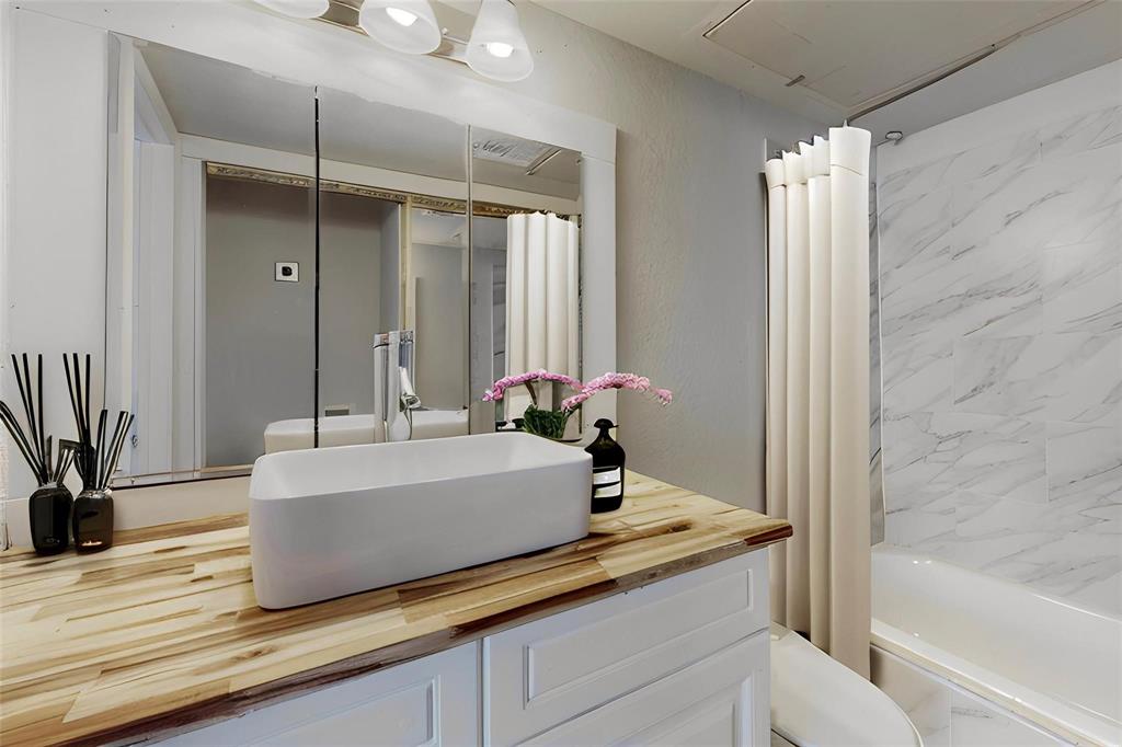 a bathroom with a tub and a shower