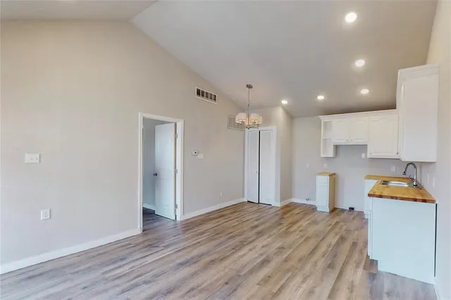 a room with a bed and a refrigerator