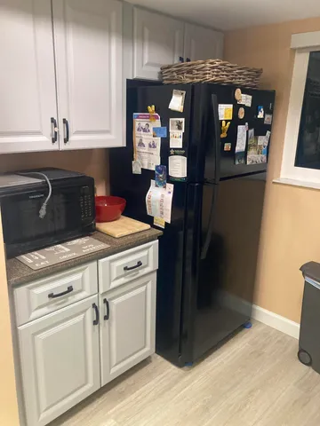 a kitchen with stainless steel appliances granite countertop a refrigerator and a stove