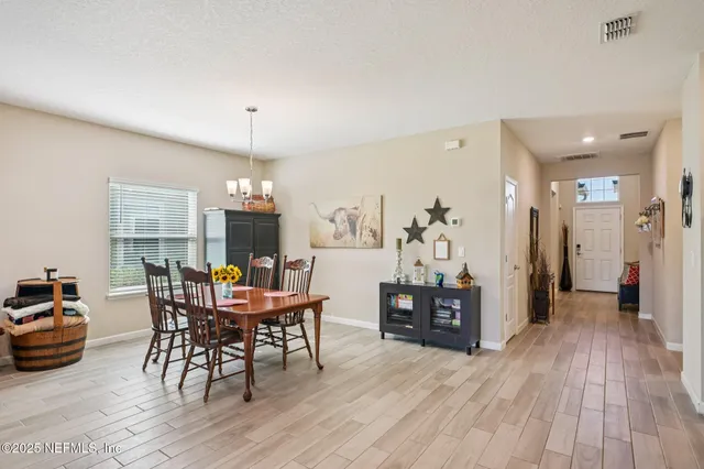 a living room with furniture a wooden floor and next to a window