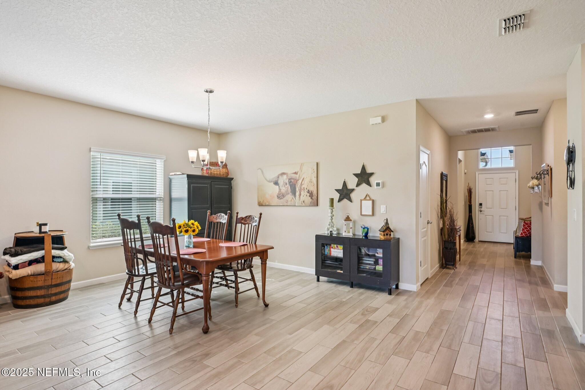 60 Cloverly Point St. Augustine, FL 32092 - Photo 19 of 44 a view of a dining room with furniture window and wooden floor