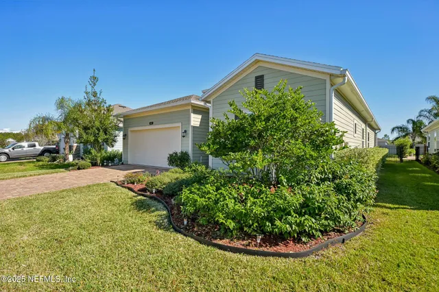 a front view of a house with garden