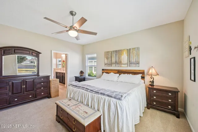 a bedroom with a bed dresser and a window