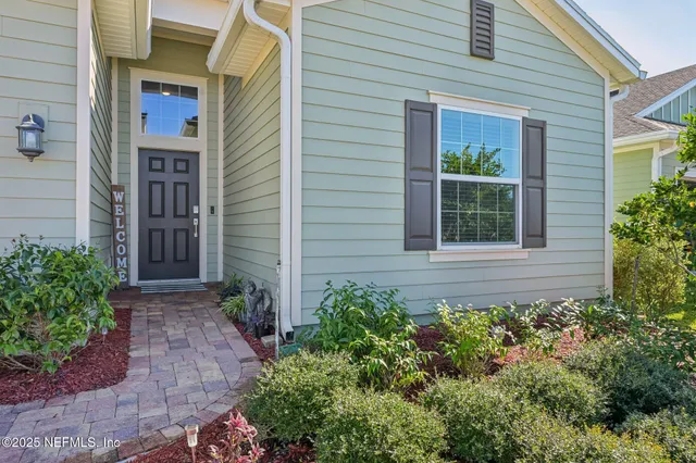 a view of a house with potted plants