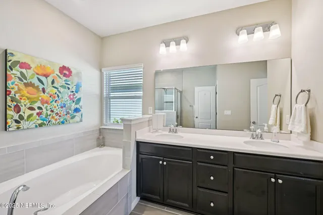 a bathroom with a double vanity sink mirror and shower