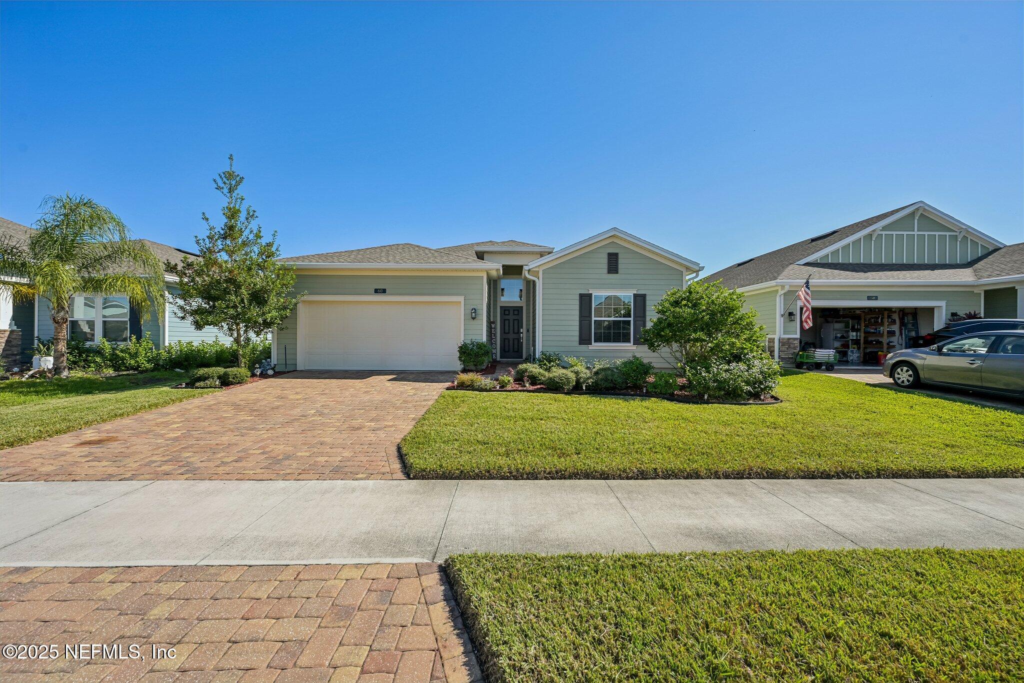 60 Cloverly Point St. Augustine, FL 32092 - Photo 37 of 44 a front view of a house with a yard and garage