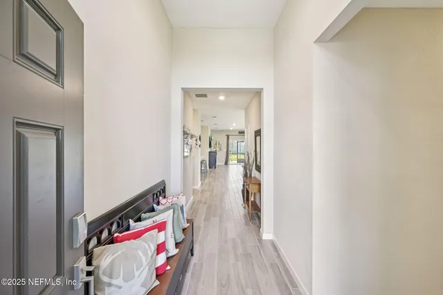 a view of a hallway view with wooden floor and closet