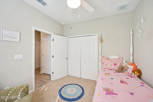 a bedroom with a bed and chandelier