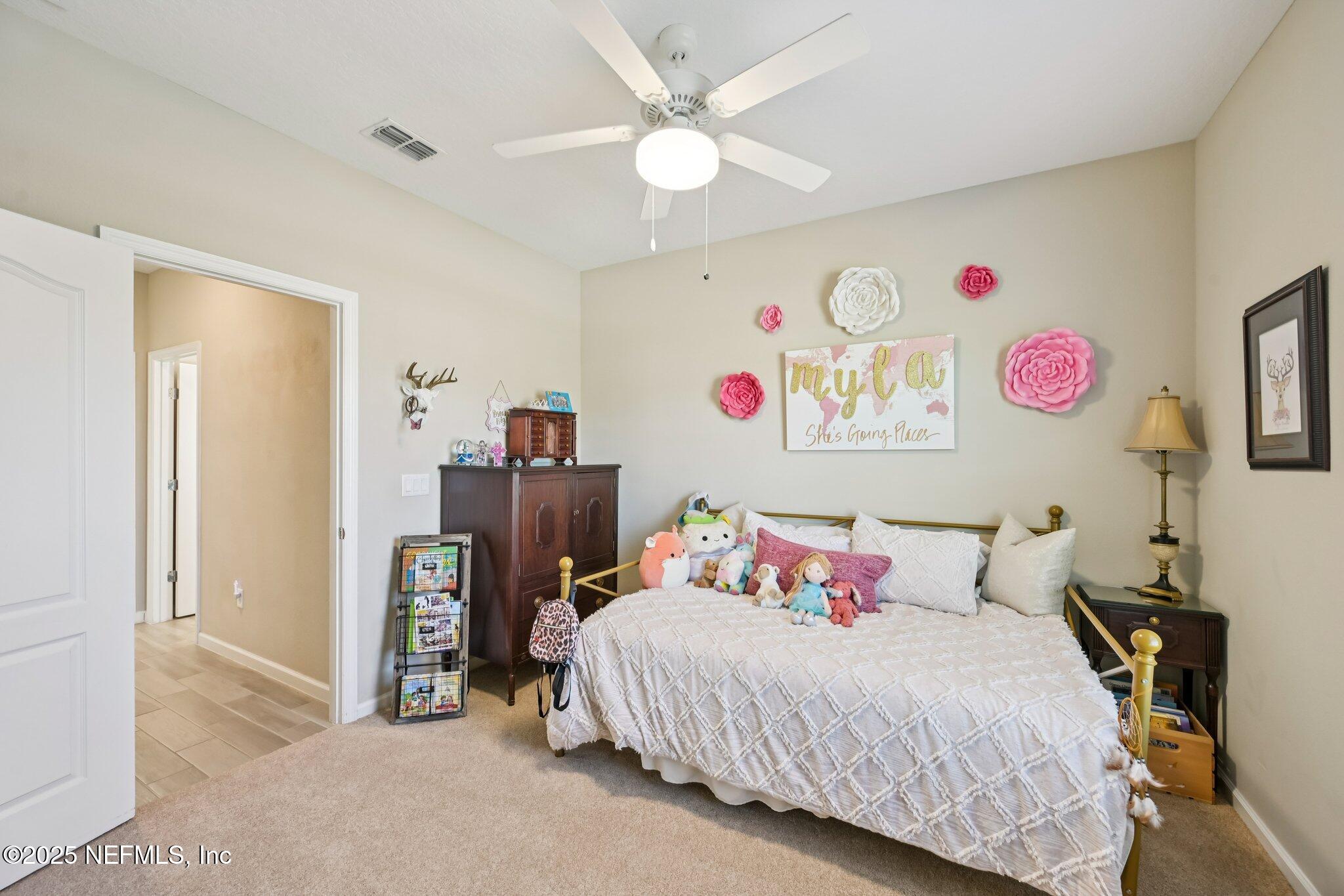60 Cloverly Point St. Augustine, FL 32092 - Photo 10 of 44 a bedroom with a bed and a chandelier