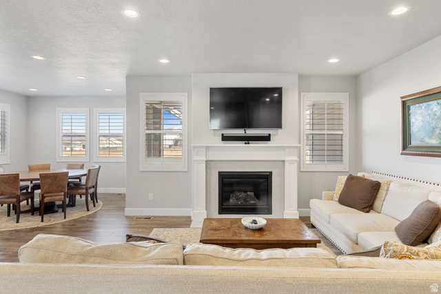 2745 Red Barn Road South Heber City, UT 84032 - Photo 6 of 51 Living area featuring a glass covered fireplace, wood finished floors, recessed lighting, and a textured ceiling