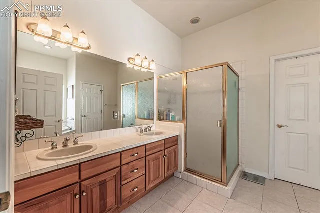 a spacious bathroom with a tub sink and mirror