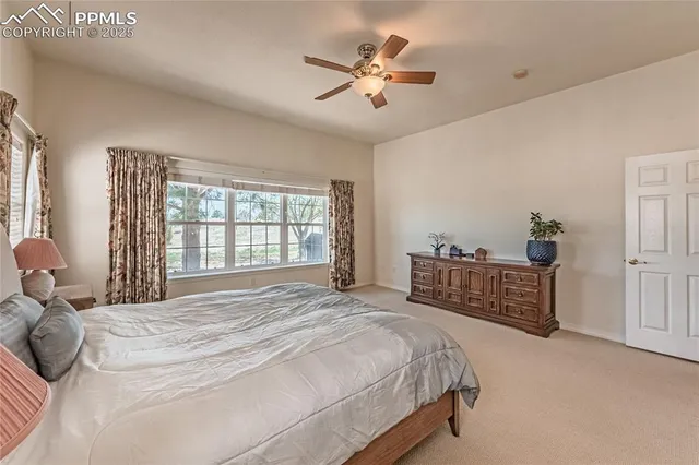 a spacious bedroom with a bed and a large window