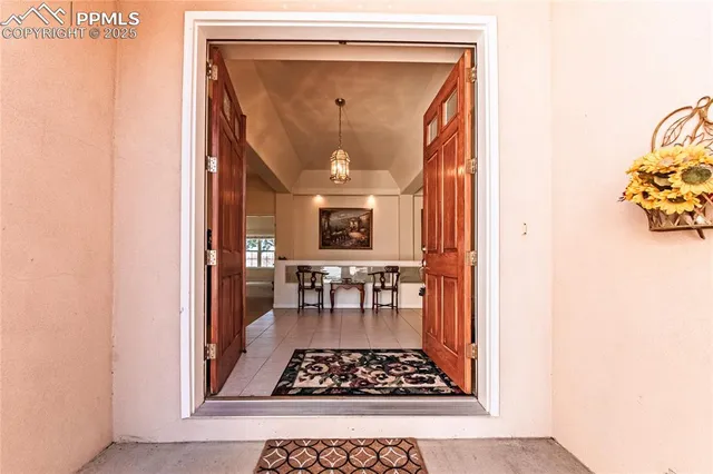 a view of a hallway with wooden floor and dining room