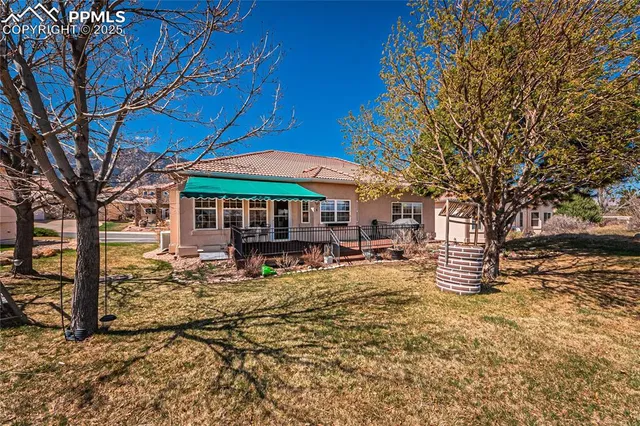 a tree in front of a white house