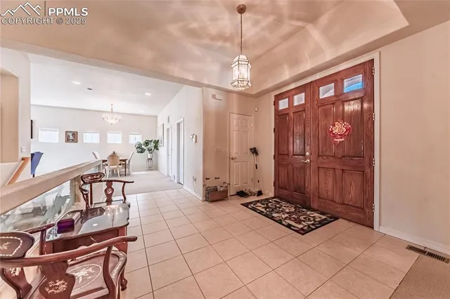 a very nice looking dining room with a large window and chairs