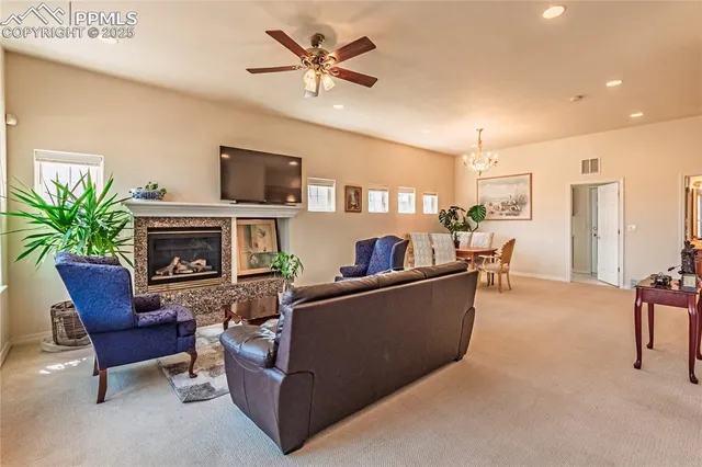 a living room with furniture a chandelier and a chandelier