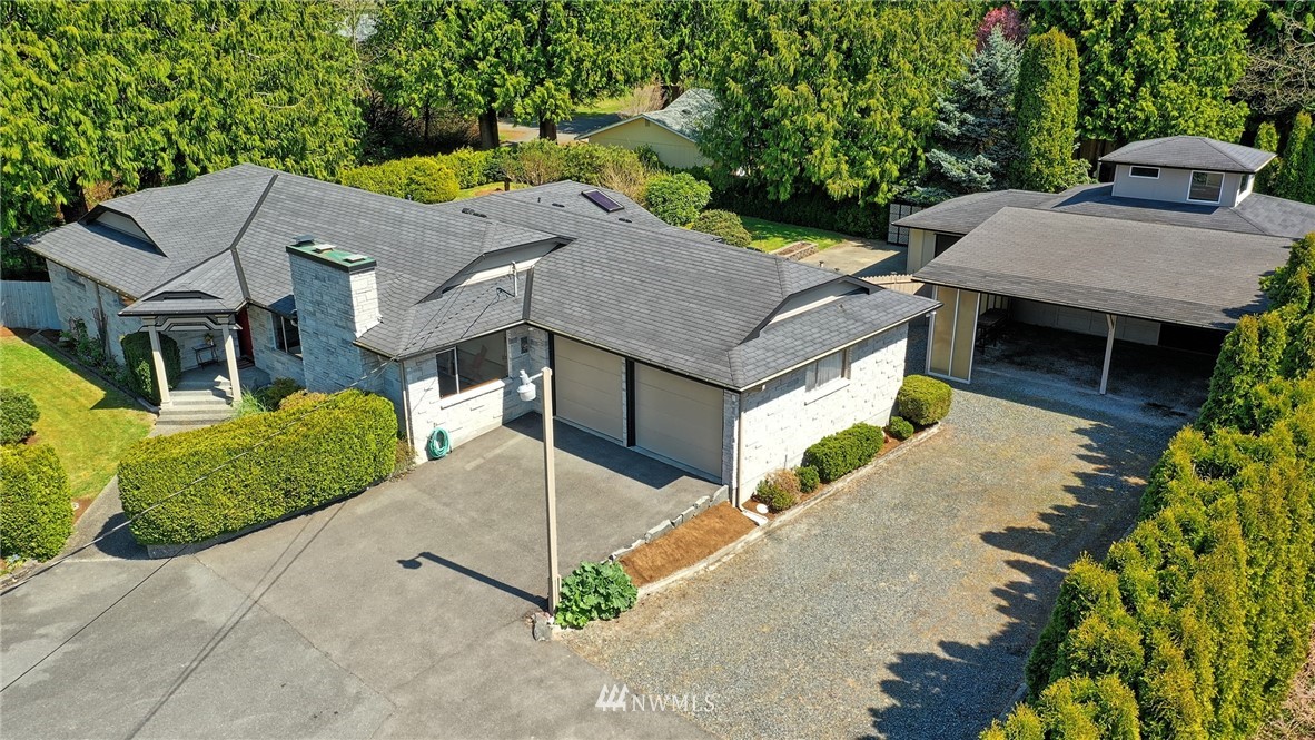 18611 North Road Bothell, WA 98012 - Photo 1 of 38 an aerial view of a house with a yard and garage