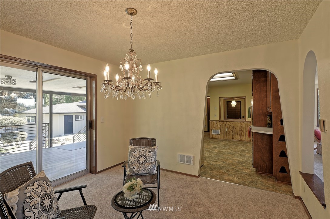 18611 North Road Bothell, WA 98012 - Photo 11 of 38 a living room with furniture and a chandelier