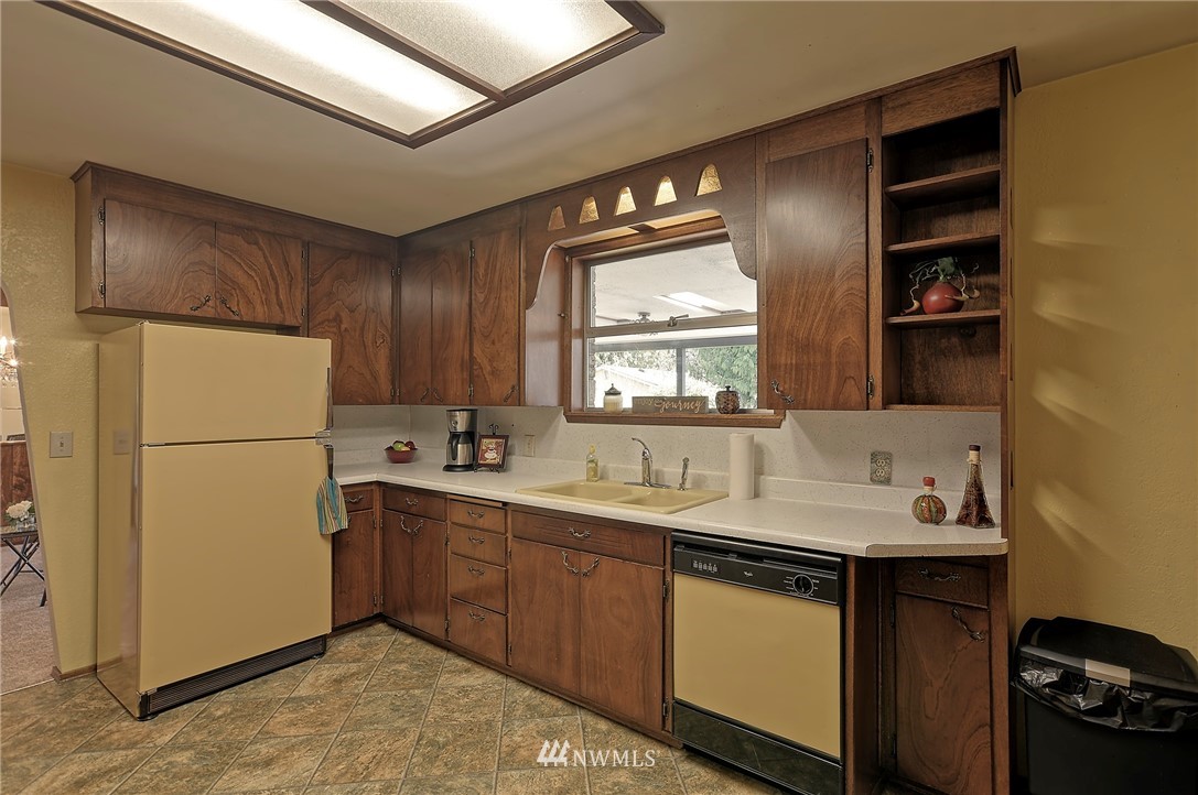 18611 North Road Bothell, WA 98012 - Photo 13 of 38 a kitchen with a sink appliances and cabinets