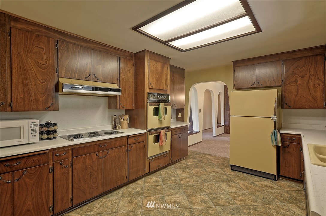 18611 North Road Bothell, WA 98012 - Photo 14 of 38 a kitchen with stainless steel appliances granite countertop a refrigerator a stove and a sink