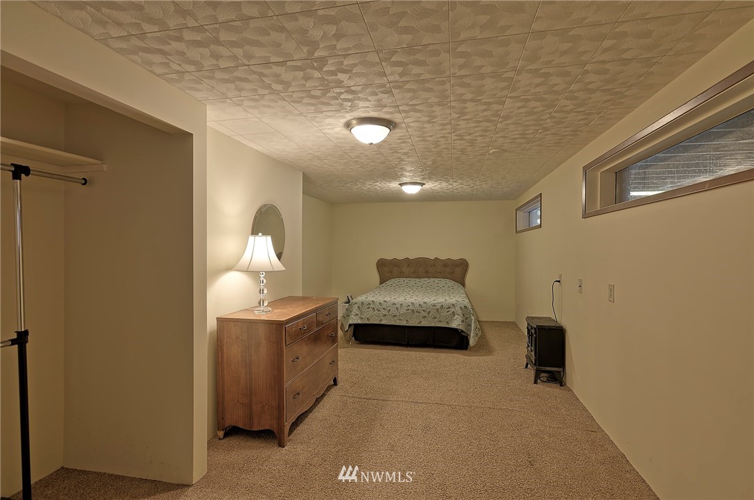 18611 North Road Bothell, WA 98012 - Photo 21 of 38 a room with furniture and a chandelier fan