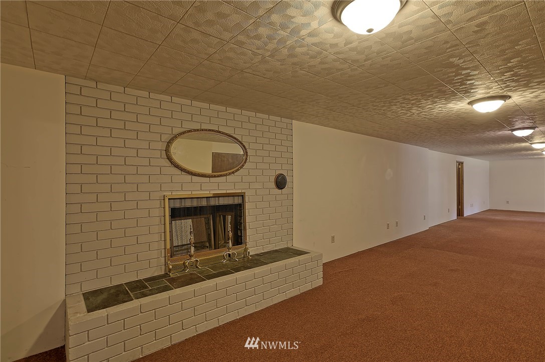 18611 North Road Bothell, WA 98012 - Photo 22 of 38 a view of empty room with a fireplace