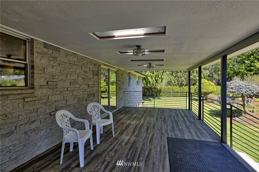 18611 North Road Bothell, WA 98012 - Photo 24 of 38 a view of a porch with furniture and wooden floor