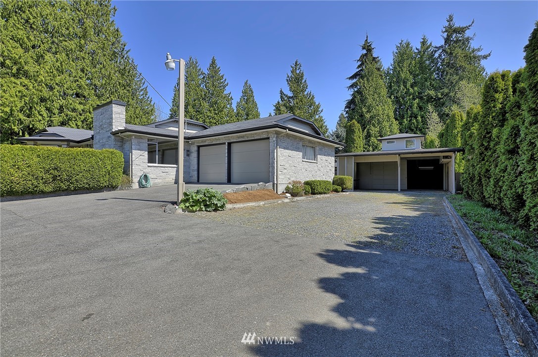 18611 North Road Bothell, WA 98012 - Photo 34 of 38 a front view of a house with a yard and trees