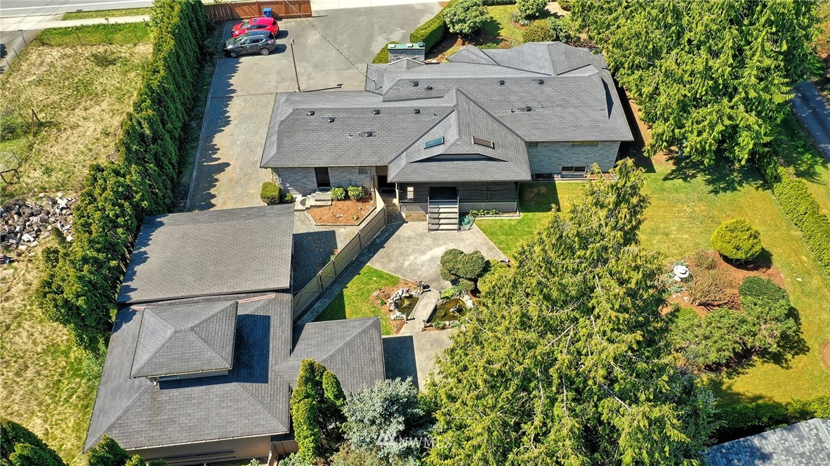 18611 North Road Bothell, WA 98012 - Photo 37 of 38 an aerial view of a house with swimming pool and large trees