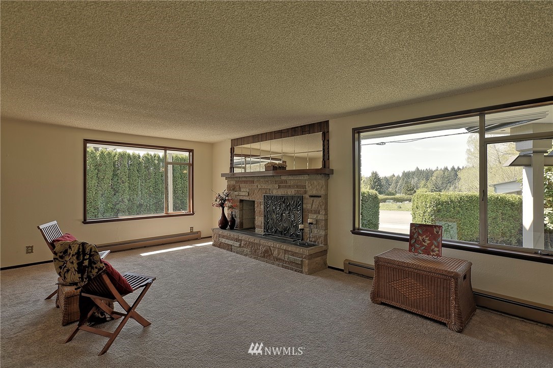 18611 North Road Bothell, WA 98012 - Photo 7 of 38 a living room with furniture and a fireplace