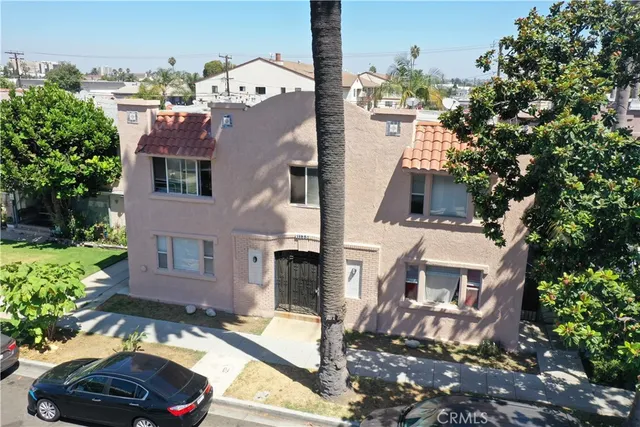 a car parked in front of a brick house with a large windows