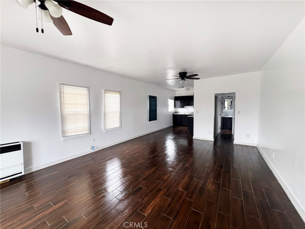 1135 East 3rd Street Long Beach, CA 90802 - Photo 9 of 16 a view of an empty room with wooden floor and a window