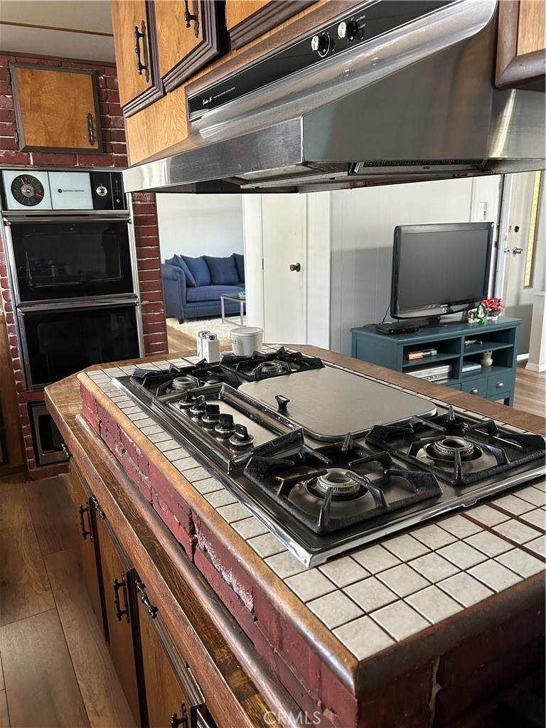 20600 South Main Street, Unit 23 Carson, CA 90745 - Photo 9 of 18 a stove top oven sitting inside of a kitchen