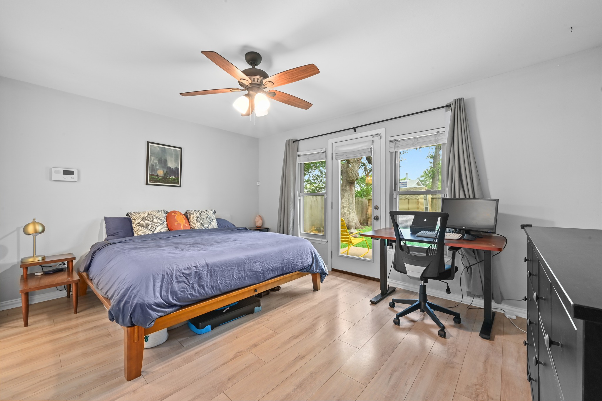 2509 Redleaf Lane Austin, TX 78745 - Photo 11 of 28 Room with light wood-finish flooring, a ceiling fan with integrated lighting, and light gray wall paint