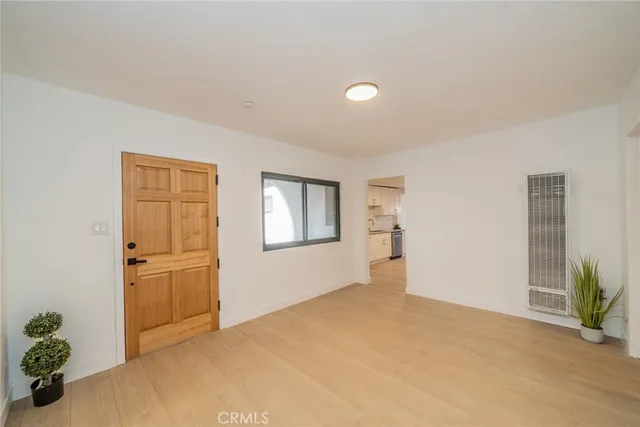 an empty room with windows and cabinet