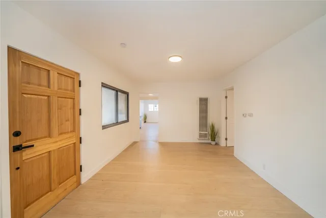 a view of a livingroom with an empty space and a window