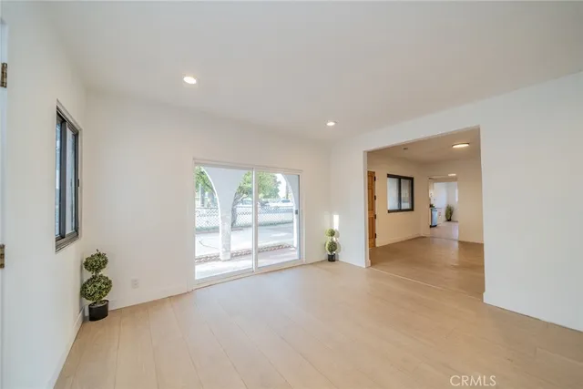 an empty room with windows and entrance