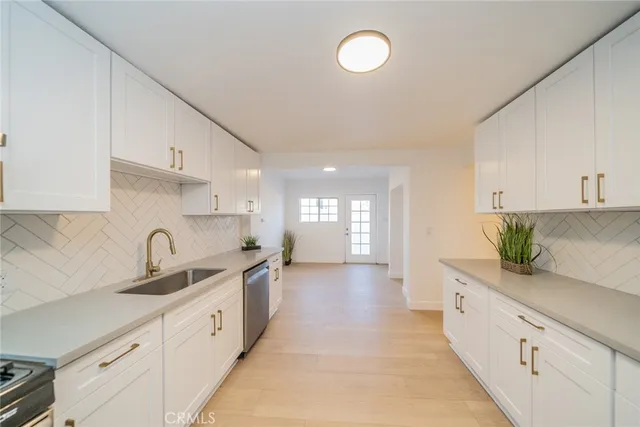 a kitchen with granite countertop a sink and cabinets