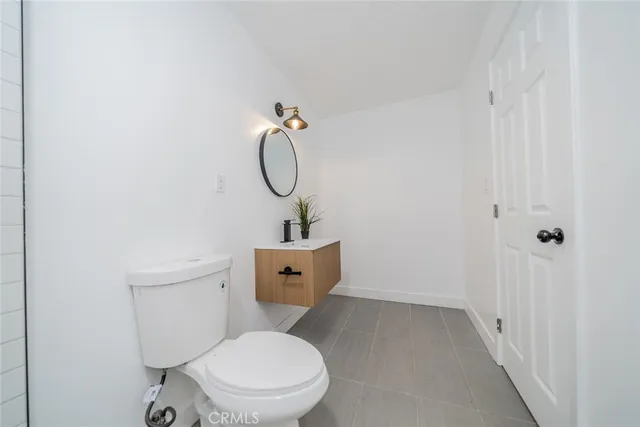 a white toilet sitting next to a shower
