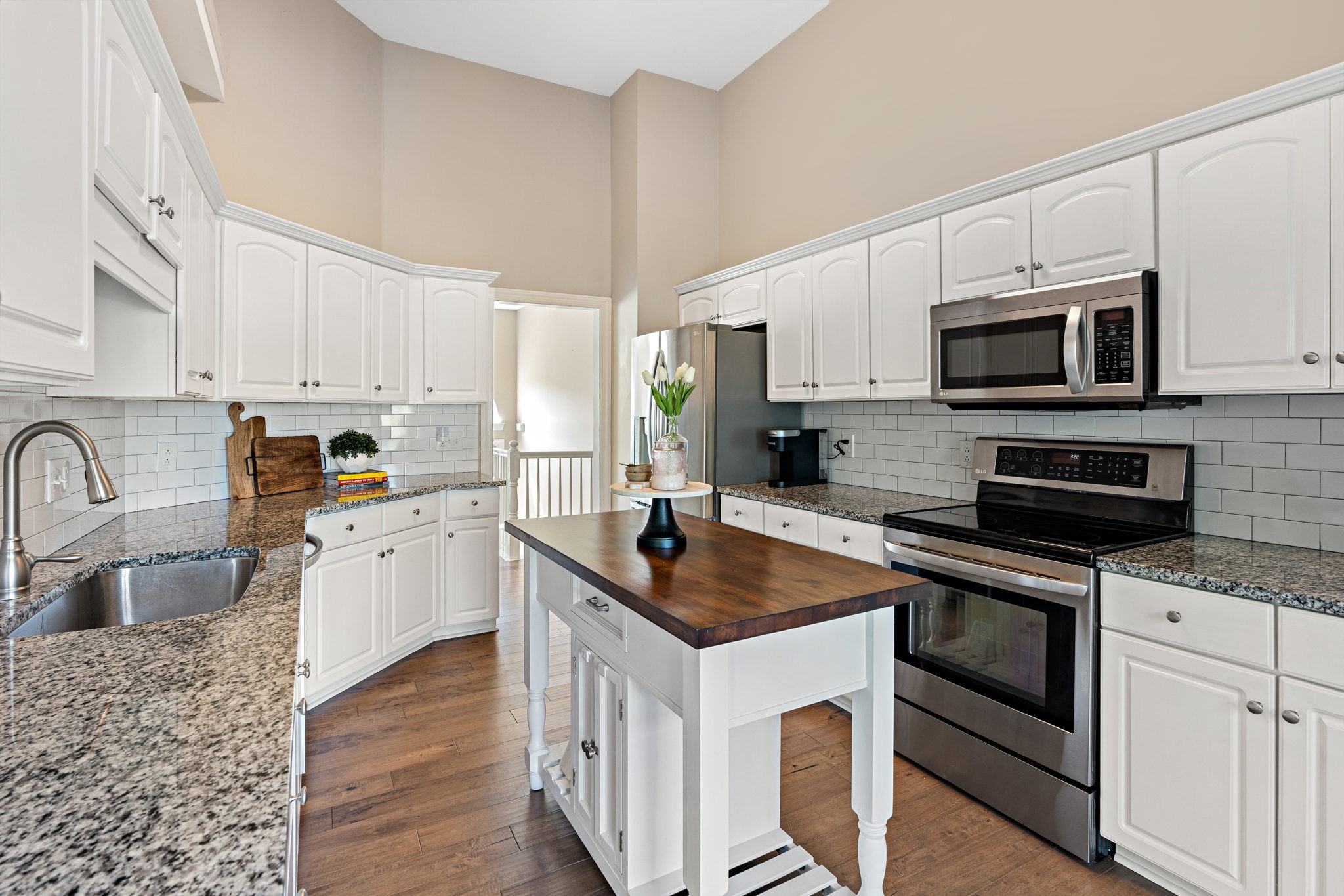 3156 Vera Valley Road Franklin, TN 37064 - Photo 11 of 44 a kitchen with stainless steel appliances granite countertop a stove top oven a sink a microwave and a refrigerator