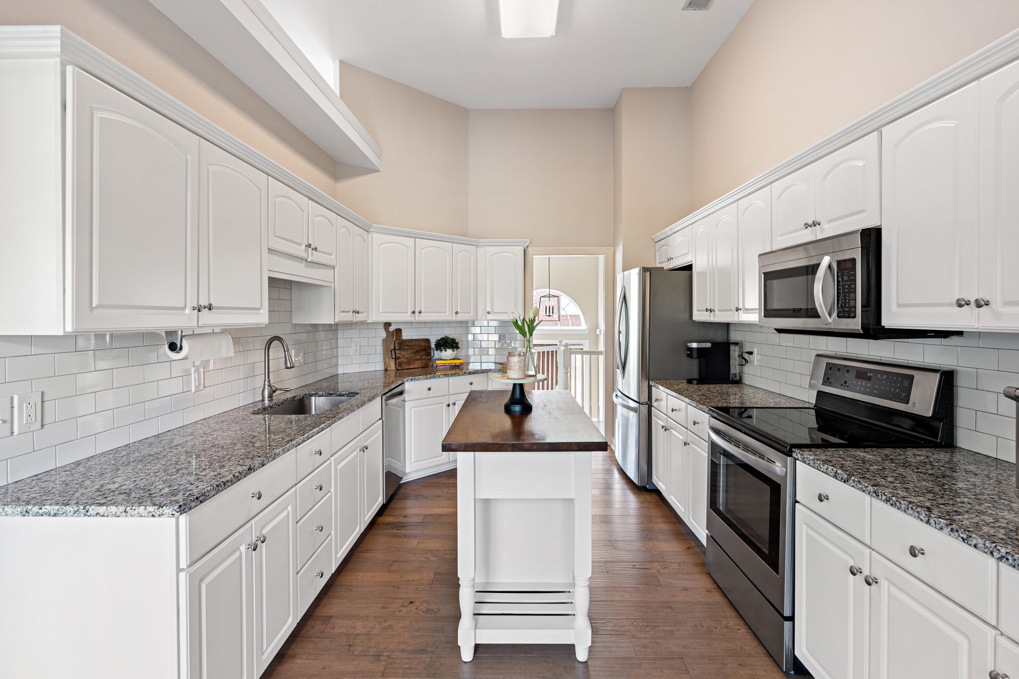 3156 Vera Valley Road Franklin, TN 37064 - Photo 9 of 44 a large kitchen with stainless steel appliances and white cabinets