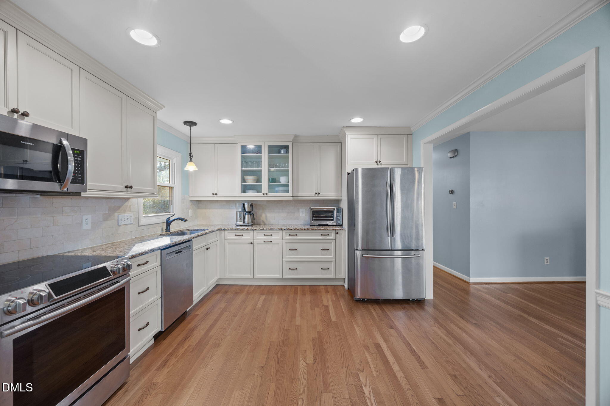 4828 Latimer Road Raleigh, NC 27609 - Photo 10 of 47 a kitchen with a wooden floor stove and refrigerator