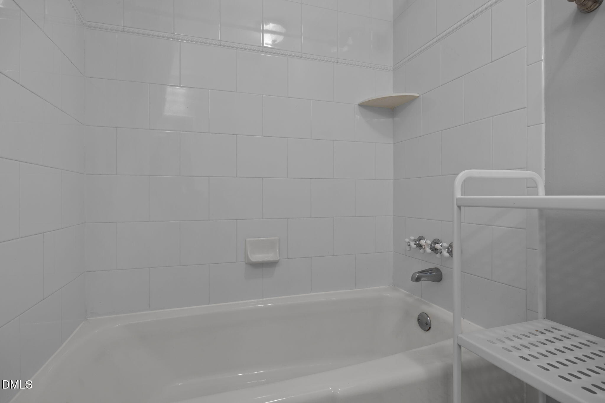 4828 Latimer Road Raleigh, NC 27609 - Photo 20 of 47 a bathroom with a bathtub and a shower