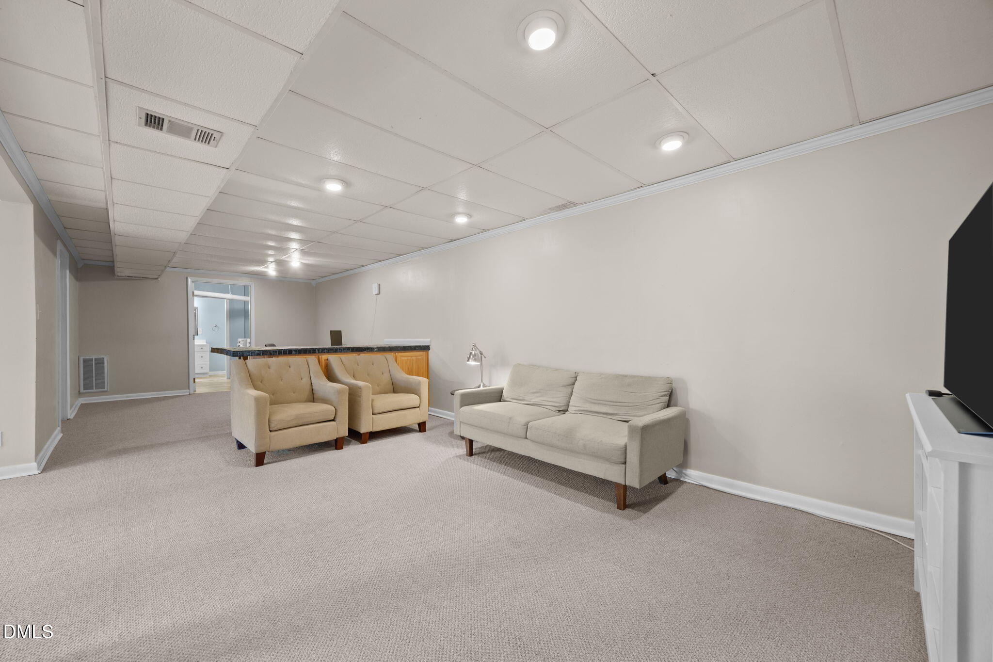 4828 Latimer Road Raleigh, NC 27609 - Photo 23 of 47 a living room with furniture and a flat screen tv