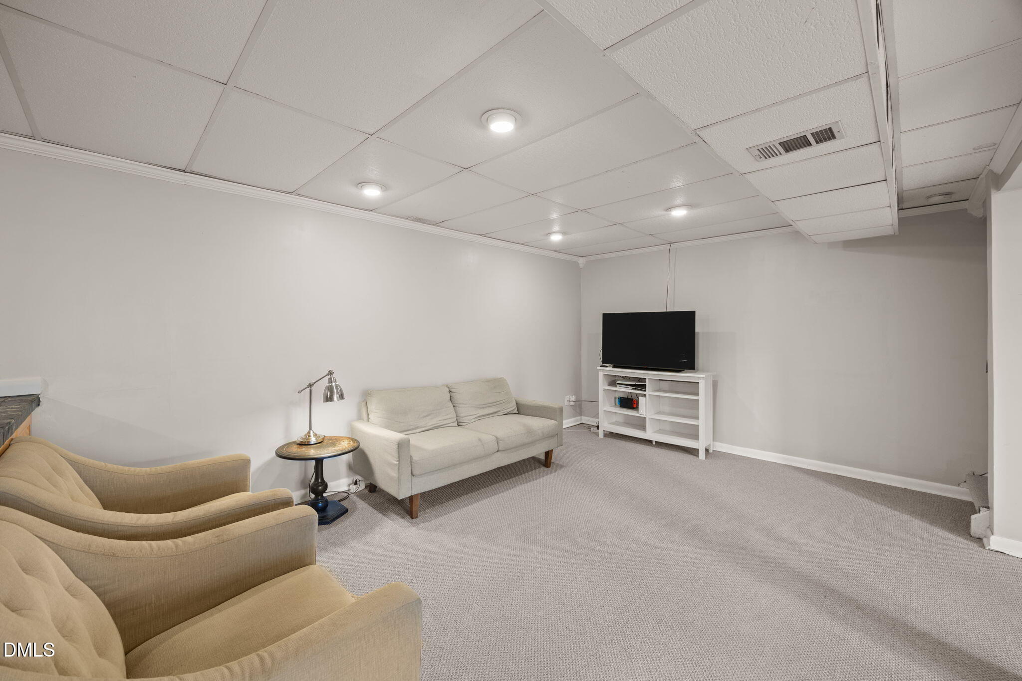 4828 Latimer Road Raleigh, NC 27609 - Photo 27 of 47 a living room with furniture and a flat screen tv