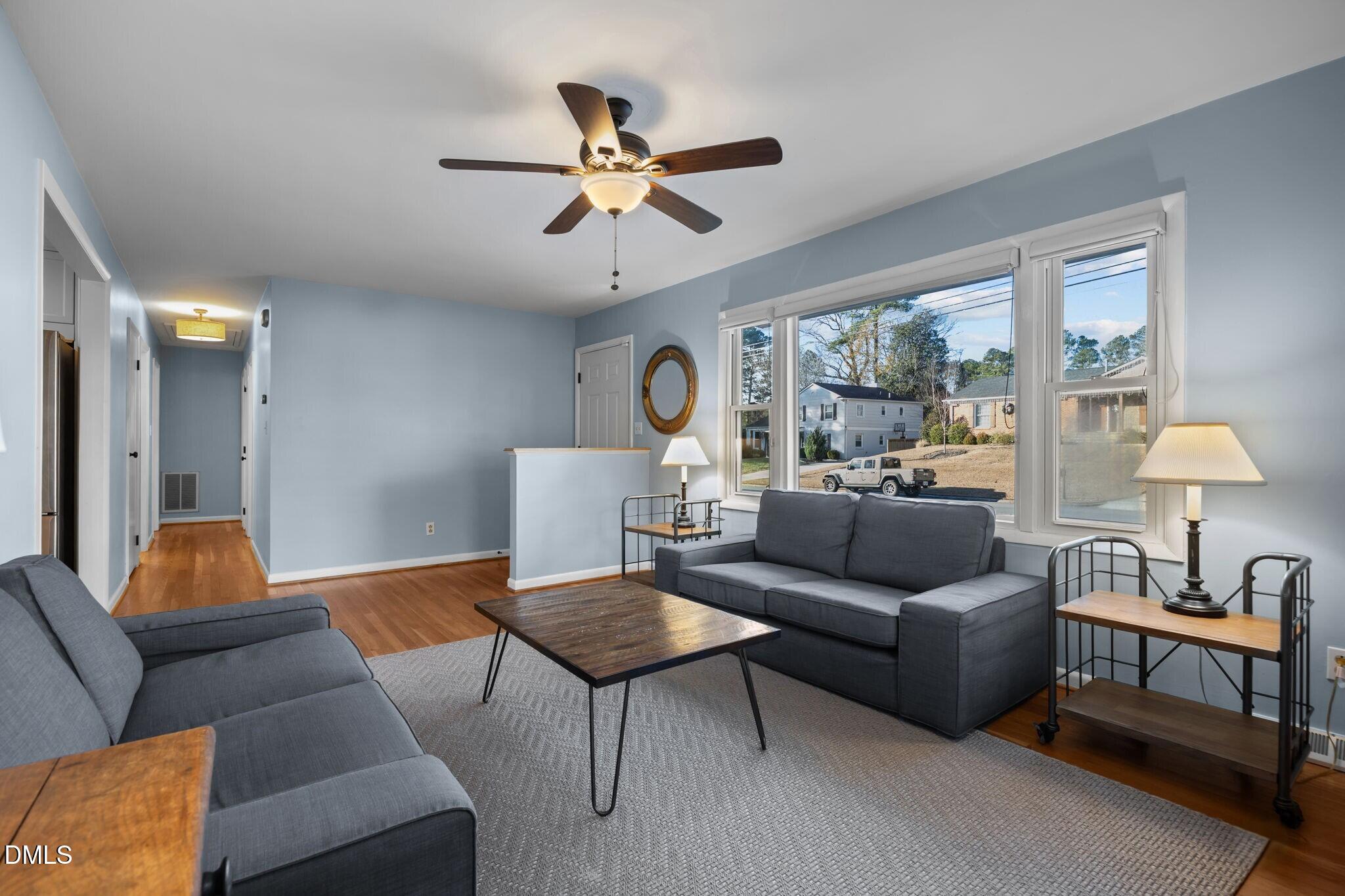 4828 Latimer Road Raleigh, NC 27609 - Photo 5 of 47 a living room with furniture ceiling fan and a window