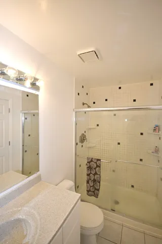 a bathroom with a toilet a sink and shower