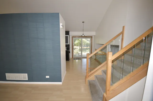 a view of entryway and hall with wooden floor